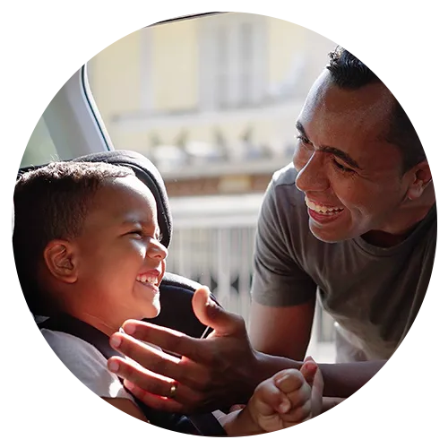 Father and young son happy in car